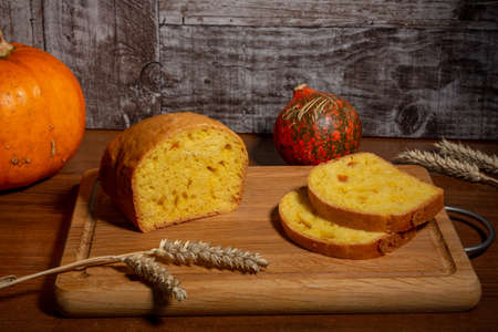 A loaf of bread with candied pumpkin. A delicious homemade traditional pie with yellow-orange...