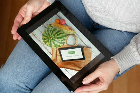 Organic Vegetables and fruits in cotton bag and tablet pc with copy space, online market, green...