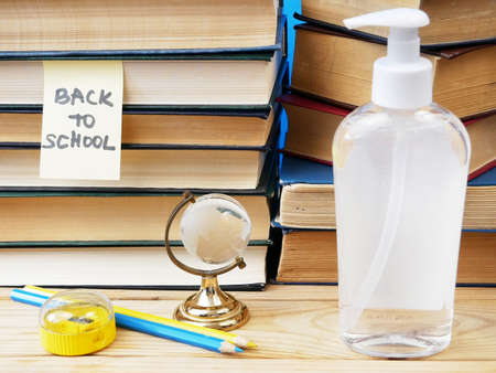 Back To School Coronavirus Covid-19, book pile, sanitizer and medical maskの写真素材