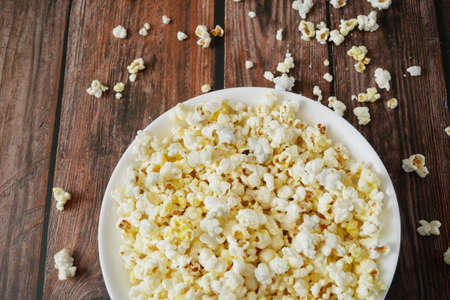 tasty popcorn in a white bowl top view