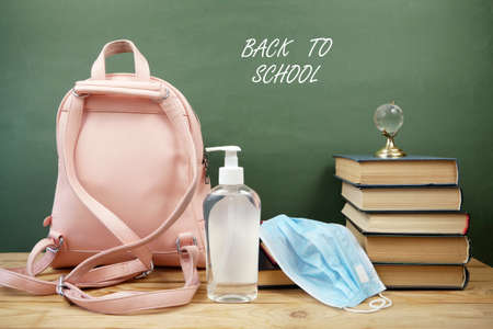 Back To School Coronavirus Covid-19, book pile, sanitizer and medical maskの写真素材
