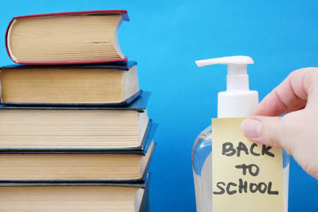 Back To School Coronavirus Covid-19, book pile, sanitizer and medical maskの写真素材