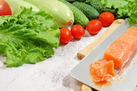 fresh salmon fish with green lettuce and vegetables, fresh salad with greens, salmon and croutons, raw food diet conceptの写真素材