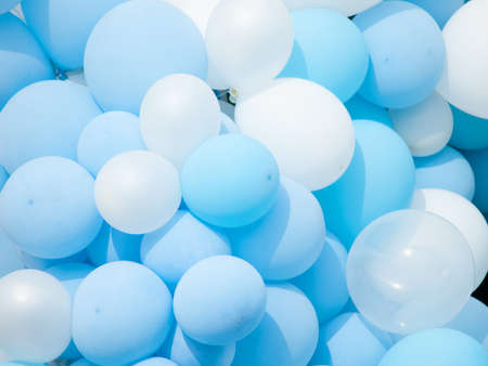 Many colorful balloons decorated wall background, blue and white balloons backgroundの写真素材
