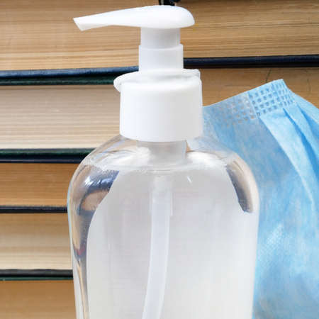 Back To School Coronavirus Covid-19, book pile, sanitizer and medical maskの写真素材