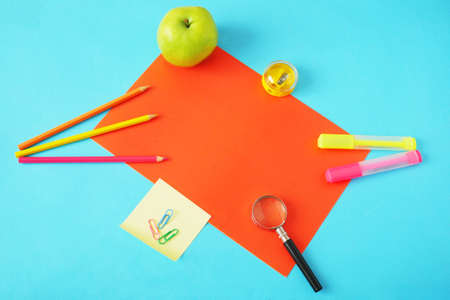 Back to school, books pile, pencils, apple, globe and apple over chalkboard backgroundの写真素材