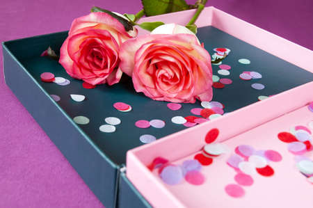 Beautiful pink roses bunch and box with confetti, closeup