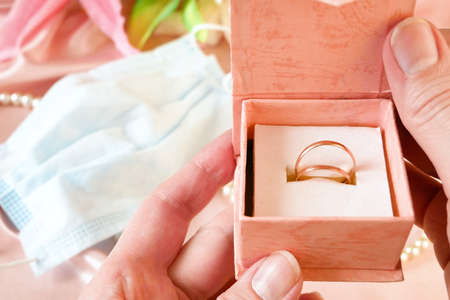 wedding rings in a gift box with flowers and pearl necklace
