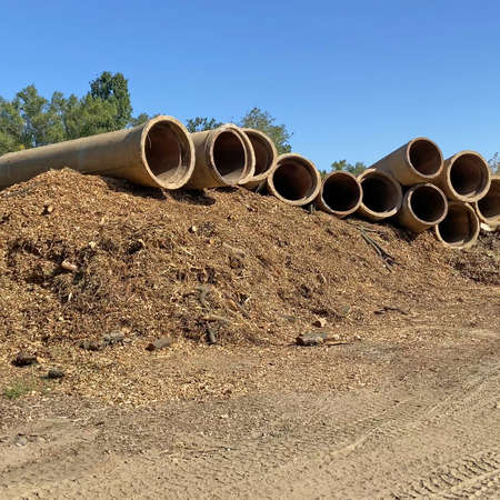 many empty big tubes in the beach, oil pipeline