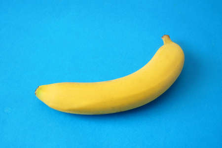 yellow fresh banana on blue baclground,の写真素材