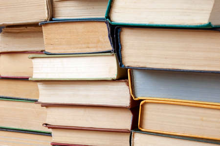 Stack of books background, many books piles, closeup