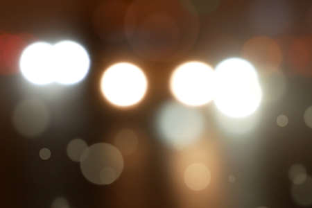 cars drive on the wet road at night, cars light disfocus of road, abstract background, blur, bokehの写真素材