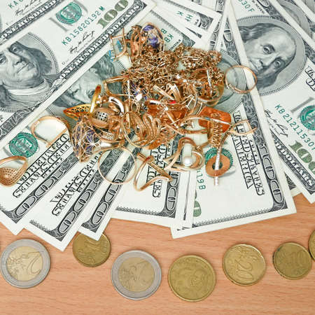 jewelry scrap of gold and silver and money, pawnshop concept, closeup
