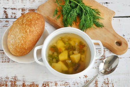 detox soup with vegetables in bowls on rustic wooden background, top view. Clean eating, dieting, vegan, vegetarian, healthy food concept, closeupの写真素材
