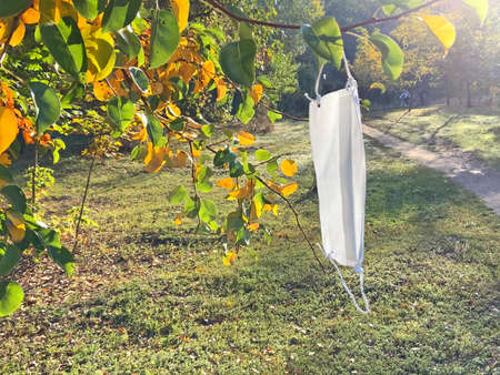 Protective used medical mask, Victory over coronavirus concept, Coronavirus contributes to...