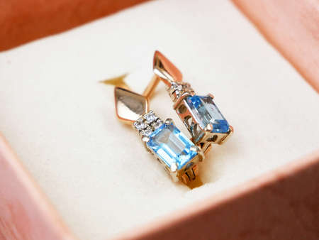 beautiful golden earring withblue topaz in present box, gift, closeupの写真素材