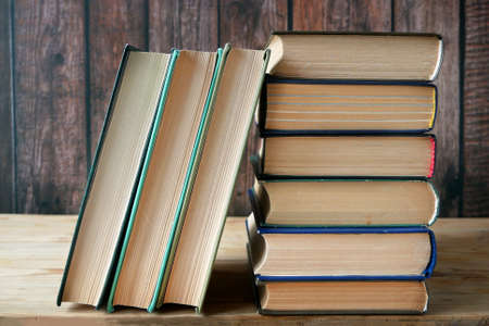 Stack of books background, many books piles