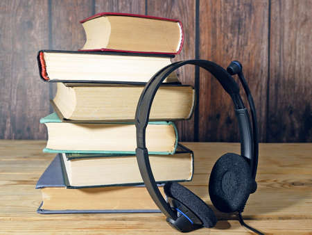 Stack of books and headphones, many books piles, online eduction, audio books conceptの写真素材