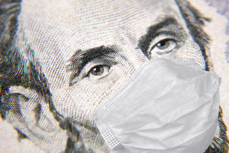 President Lincoln with face mask on 5 dollar money bill, covid-19, coronavirus in USA, macro,...