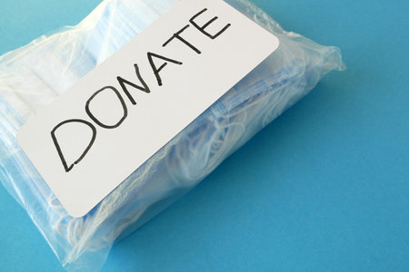 medical face masks and respirators for donation on blue backgroundの写真素材