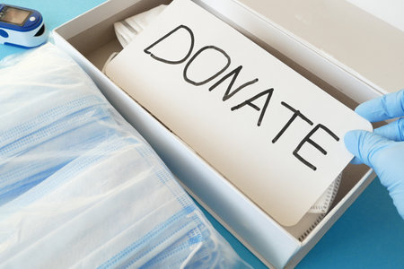 medical face masks and respirators for donation on blue background