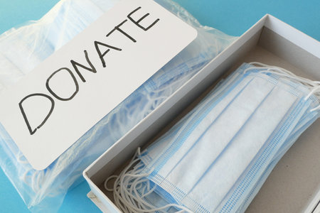medical face masks and respirators for donation on blue backgroundの写真素材