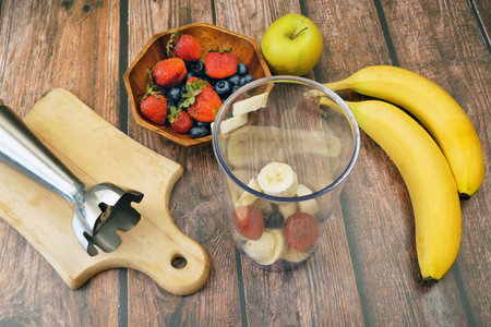 morning breakfast with fresh fruits and yogurt on a background of juicy bananasの写真素材