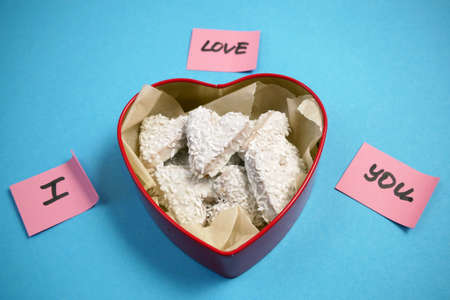 Composition with decorated heart shaped cookies in box, top view. Valentine's day treat, closeupの写真素材