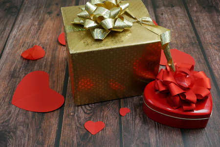 many presents box for valentine's day and hearts symbols on wooden background, closeupの写真素材