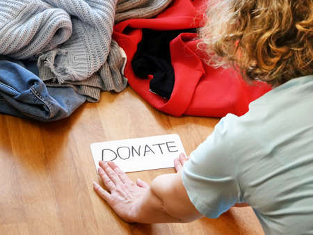 woman sorting clothes for donation at home, closeupの写真素材