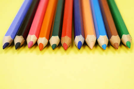 Colorful Pencils raw on yellow background, closeupの写真素材