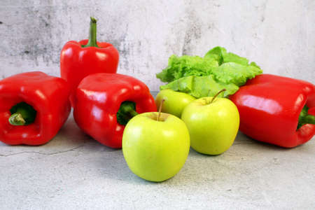 sweet red pepper, apple and lettuce ion gray backgorund, closeupの写真素材
