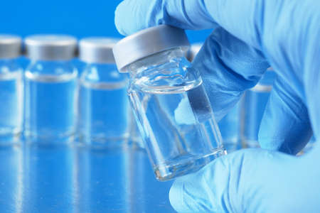 many bottles of covid-19 coronavirus vaccine, production medicine vaccine, closeup