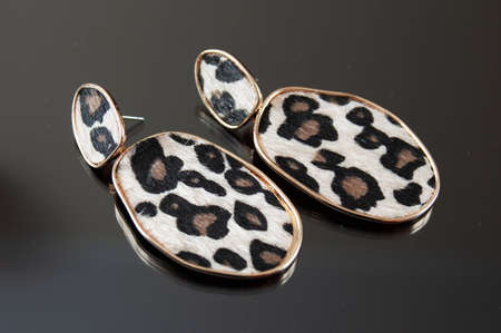 modern woman earrings on black background