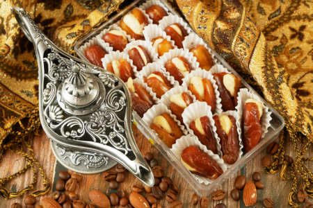 Eastern sweets with nuts, candy, dates in box background, closeupの写真素材
