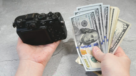 digital camera and money, store selling photographic equipment, pawnshop concept, closeupの写真素材