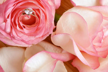 golden ring with diamond roation in pink roses flowers, closeupの写真素材