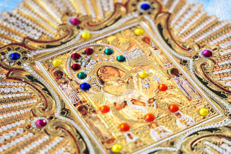 Traditional orthodox icon of Mother Mary in rich decoration, closeup