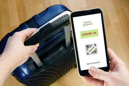 Vaccination passport on a mobile phone allowing travel in hand. Vaccination against the coronavirus...