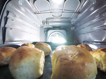 Heap of delicious fresh pies with fruits in the oven, closeupの写真素材