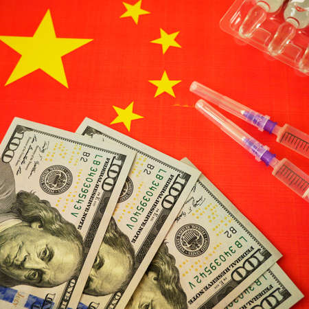 syringe with a vaccine and money on background of the Chinese flag