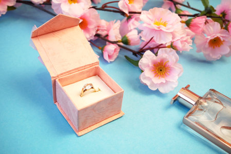 wedding ring in a gift box and tree blossom flowers and medical masks, wedding in spring time...