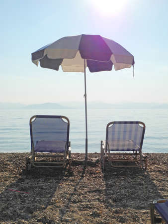 empty beaches, sun loungers and beach umbrellas wait tourists, Corfu, Greece, tourism problems after...