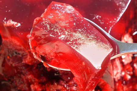 Fruit jelly with fresh strawberry. Healthy food. Strawberry jelly on white background. Summer dessert with fruit jelly and fresh strawberry. Closeupの写真素材