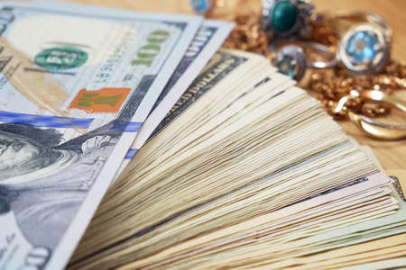 ash money and jewelry, pawn shop and buy and sell precious metals concept, golden rings, necklace...