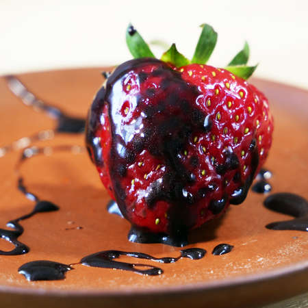 Fresh tasty strawberry covered with black chocolate, chocolate drips on strawberries, closeupの写真素材