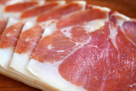 Slices Of Jamon On The Wooden Background, closeup