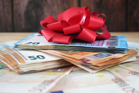 Money Gift, Money and bow on wooden background, closeupの写真素材
