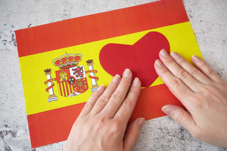 I love Spain. Hands make heart on Spanish flag background. 12 october national day of Spain,...