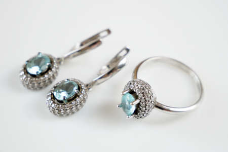 earring and ring set with big blue topaz and white diamonds around, jewerly shop, pawnshop concept, closeupの写真素材